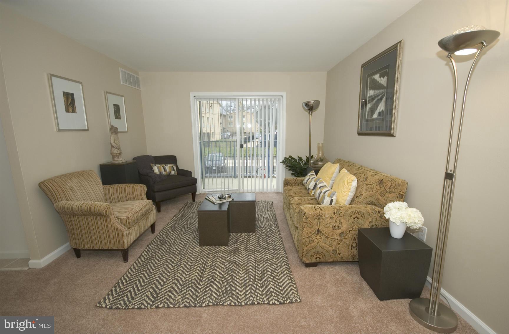 2351 16th Street Southeast, Unit 302 Washington, DC 20020 - Photo 6 of 27 a living room with furniture rug and window