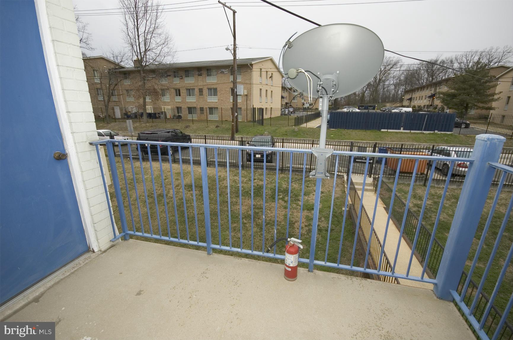 2351 16th Street Southeast, Unit 302 Washington, DC 20020 - Photo 8 of 27 a view of balcony with wooden floor and fence
