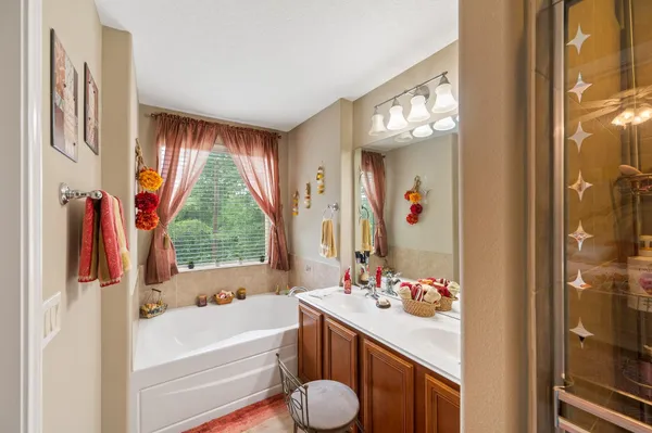 a bathroom with a tub sink and mirror