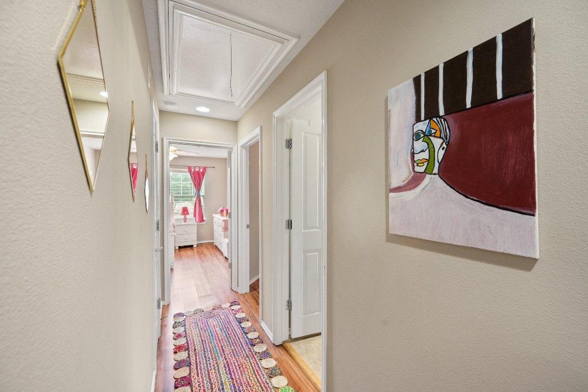 13600 Breton Ridge Street, Unit 25E Houston, TX 77070 - Photo 23 of 39 a hallway with wooden floor and windows