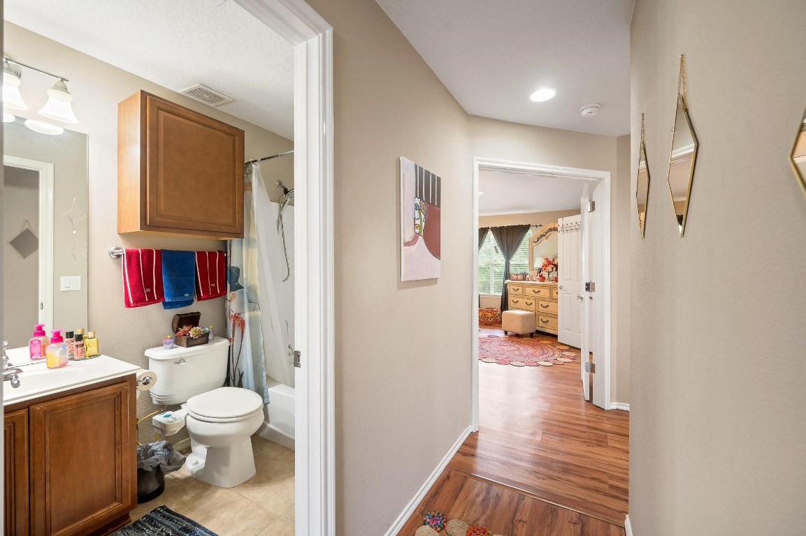 13600 Breton Ridge Street, Unit 25E Houston, TX 77070 - Photo 25 of 39 a bathroom with a sink vanity mirror and toilet