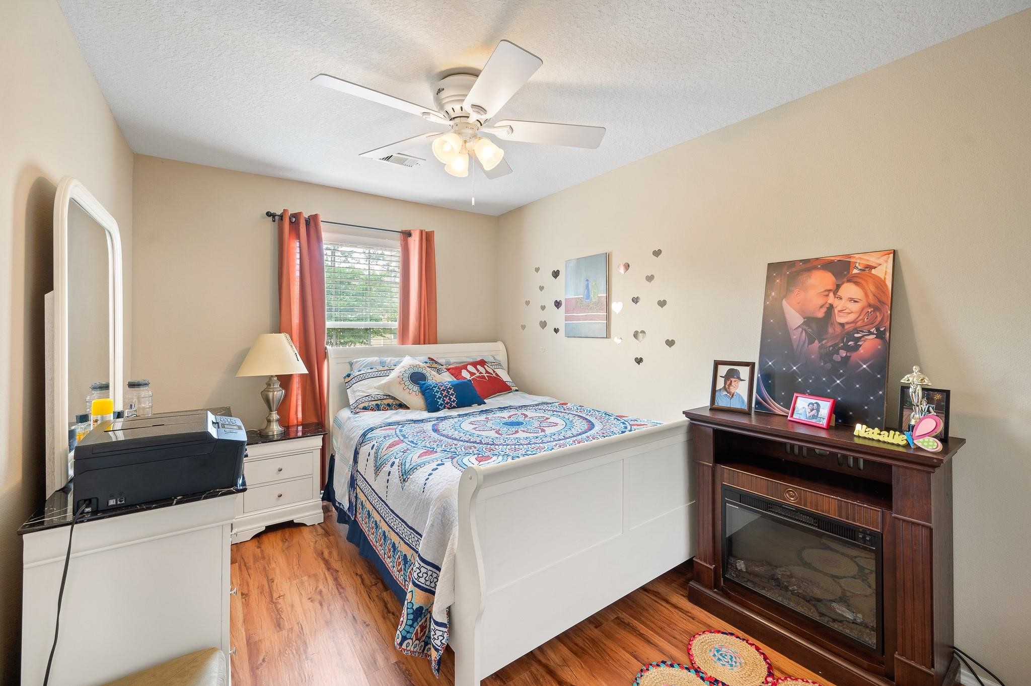13600 Breton Ridge Street, Unit 25E Houston, TX 77070 - Photo 26 of 39 This bedroom is designed to provide a practical and inviting space where residents can relax and unwind, showcasing a blend of durability, comfort, and aesthetic appeal.