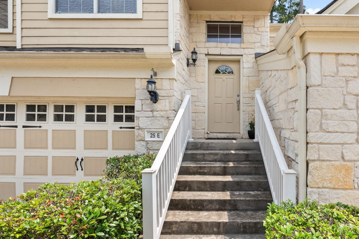 13600 Breton Ridge Street, Unit 25E Houston, TX 77070 - Photo 3 of 39 a view of a house with large windows and a small yard