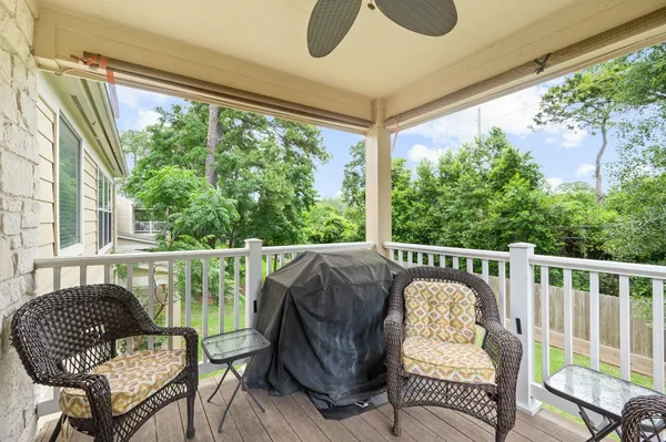 a balcony view with a large window and sitting space