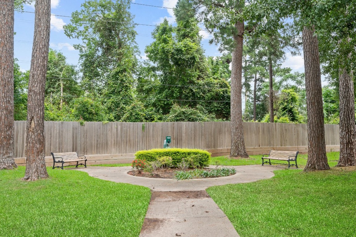 13600 Breton Ridge Street, Unit 25E Houston, TX 77070 - Photo 35 of 39 a view of a backyard with potted plants and wooden fence