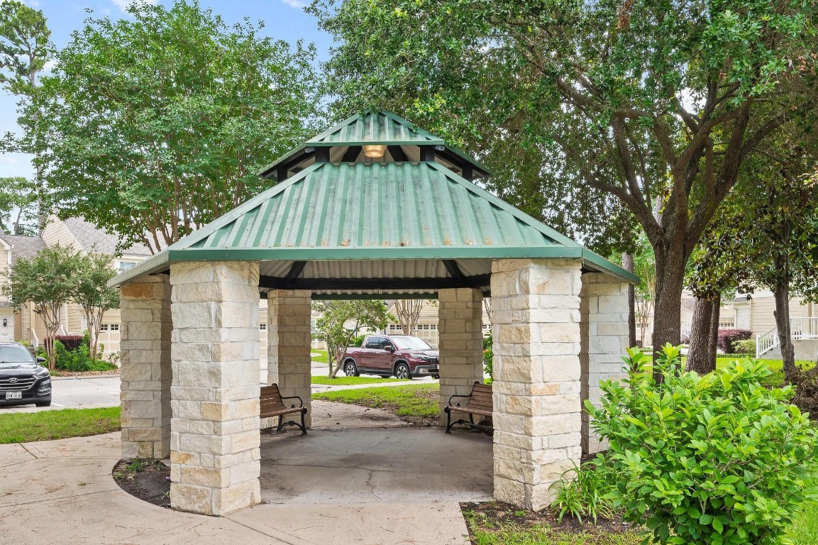 13600 Breton Ridge Street, Unit 25E Houston, TX 77070 - Photo 36 of 39 a front view of a house with garden