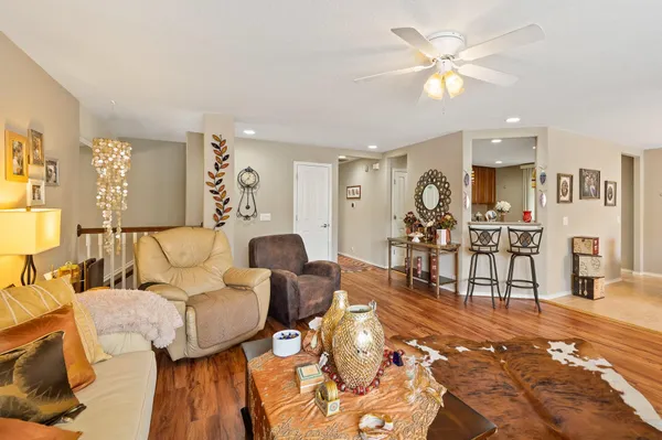 a living room with furniture and wooden floor
