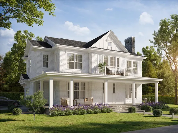 a front view of a house with a yard and trees