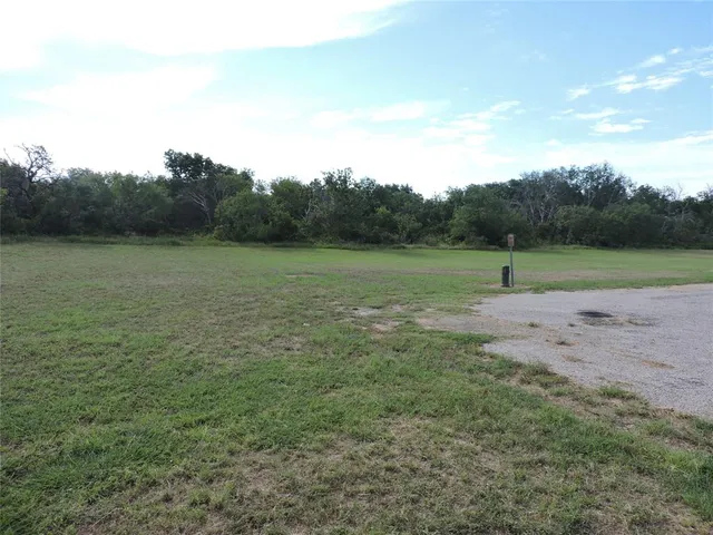 a view of outdoor space with green field and trees