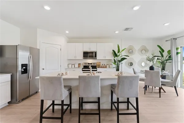 a kitchen with a sink and white cabinets