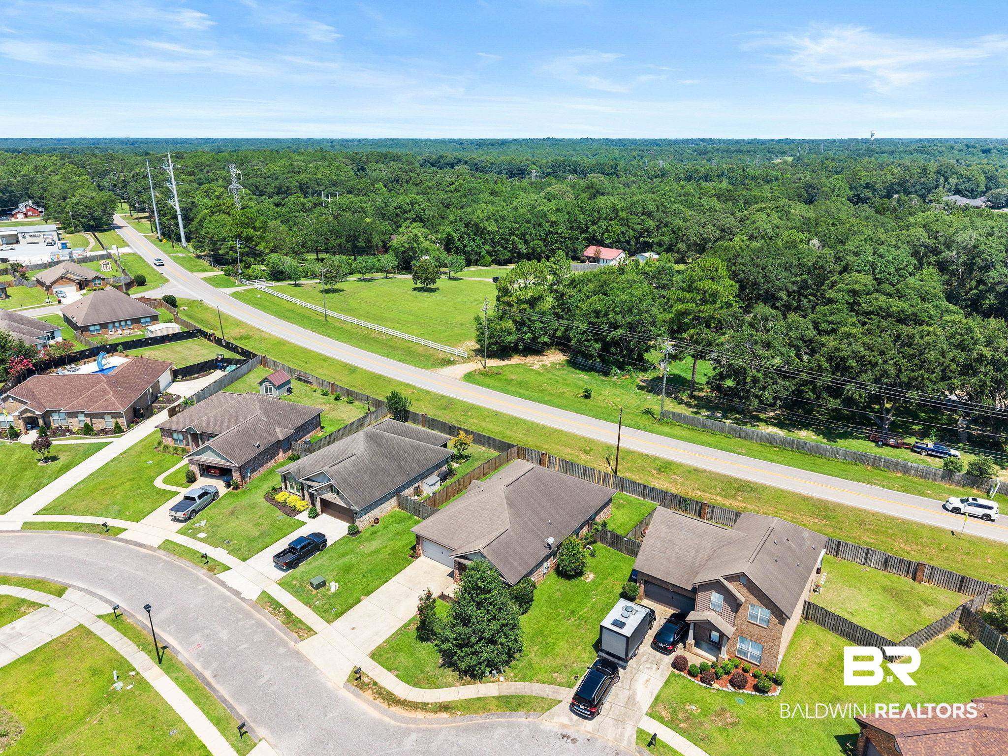 2216 Livingstone Court Mobile, AL 36695 - Photo 51 of 62 Aerial perspective showcasing a residential area with varied home designs, surrounded by expansive green spaces and mature trees