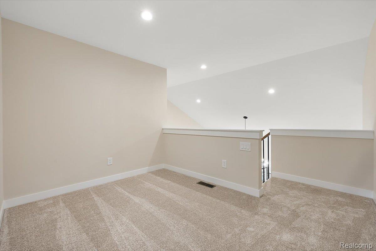 2044 Breckenridge Court Rochester, MI 48309 - Photo 25 of 33 Empty room with recessed lighting, light carpet, and lofted ceiling