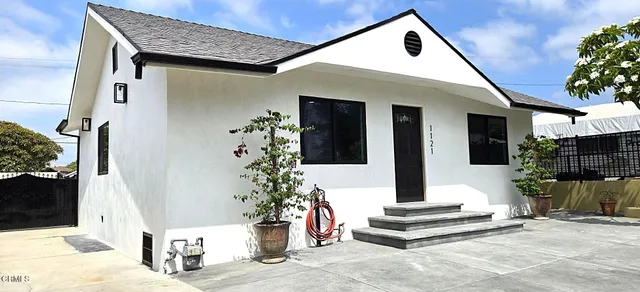 a view of a livingroom with a window and wooden floor