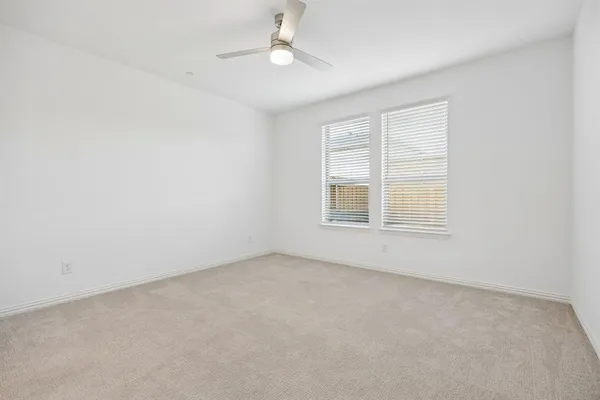 an empty room with a window and fireplace