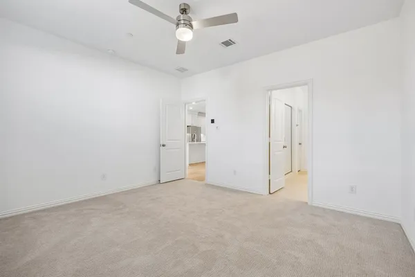 an empty room with a ceiling fan and a ceiling fan