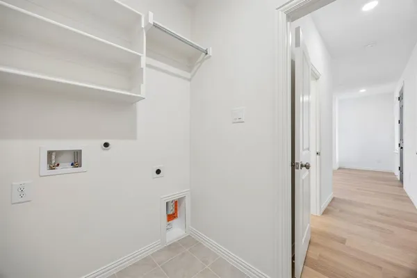 a view of hallway with wooden floor