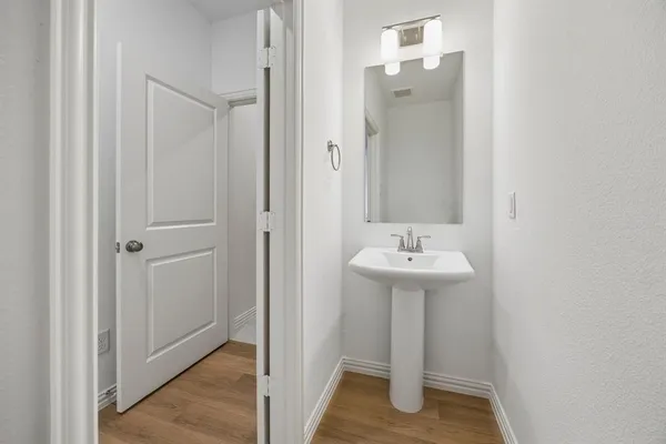 a bathroom with a sink a mirror and shower