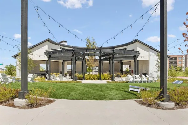 a front view of a house with a yard outdoor seating and garage