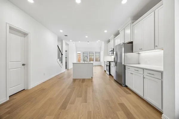 a view of a kitchen with wooden floor
