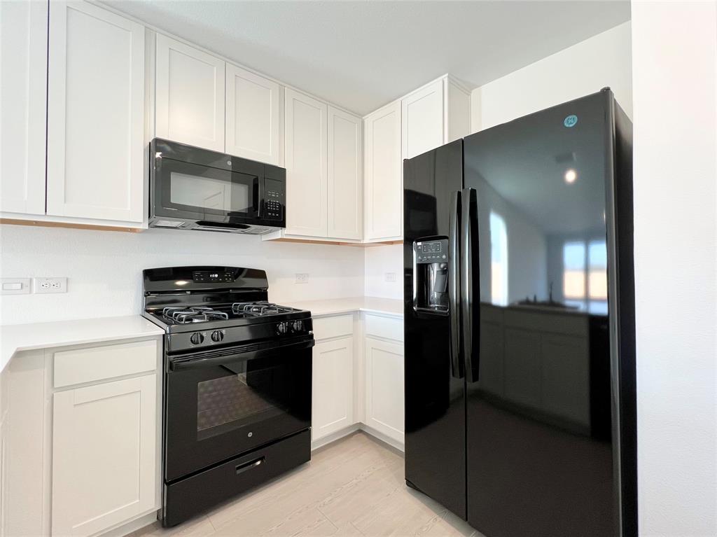 4012 Twinleaf Drive Crowley, TX 76036 - Photo 11 of 39 a kitchen with stainless steel appliances granite countertop a refrigerator and a stove top oven