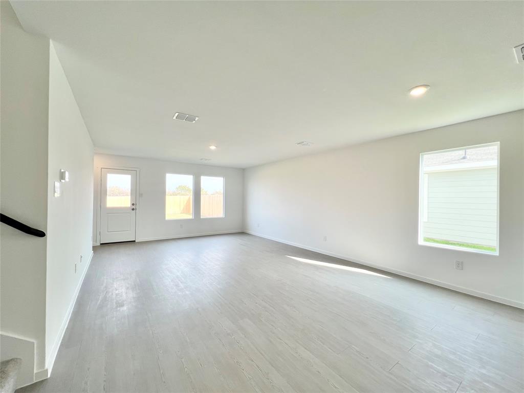 4012 Twinleaf Drive Crowley, TX 76036 - Photo 12 of 39 an empty room with wooden floor and windows