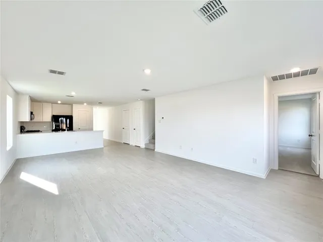 a view of a kitchen with a sink and a refrigerator