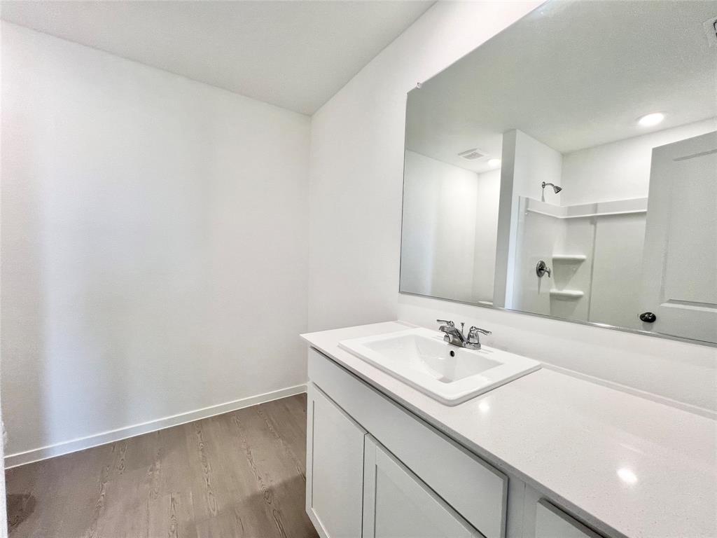 4012 Twinleaf Drive Crowley, TX 76036 - Photo 17 of 39 a bathroom with a sink a vanity and a mirror