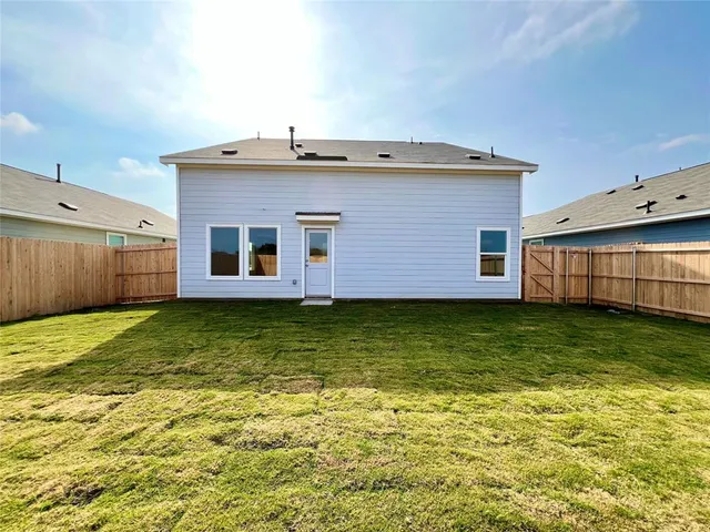 a view of a backyard with table and chairs