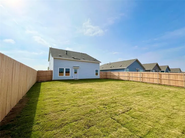 a house view with swimming pool in front of it