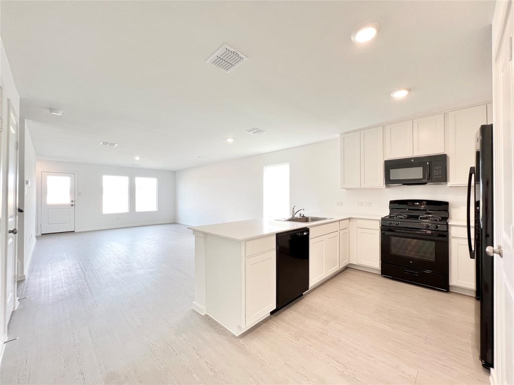 4012 Twinleaf Drive Crowley, TX 76036 - Photo 39 of 39 a large kitchen with stainless steel appliances granite countertop a stove and a refrigerator