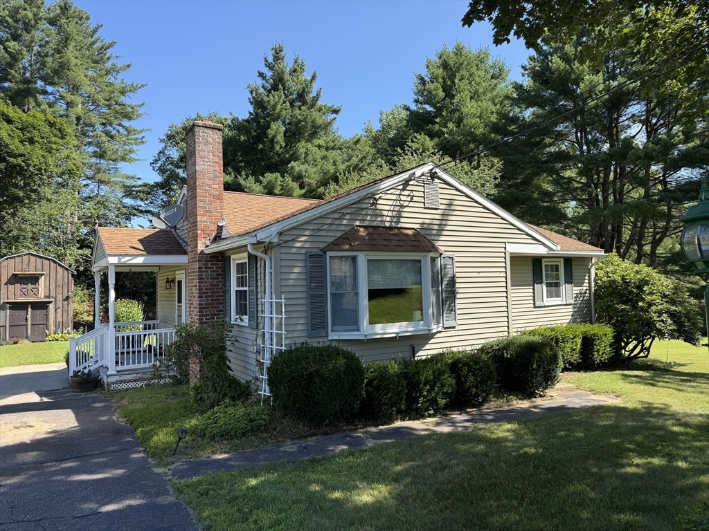 1 Anna Street Ware, MA 01082 - Photo 2 of 26 a front view of a house with a yard and potted plants