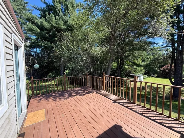 a view of balcony with wooden floor and fence