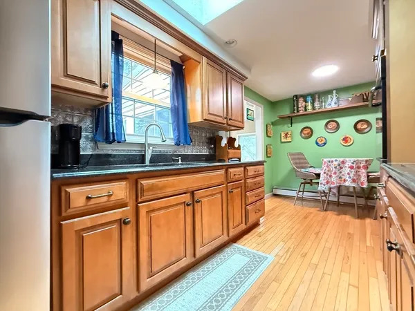 a kitchen with cabinets and wooden floor