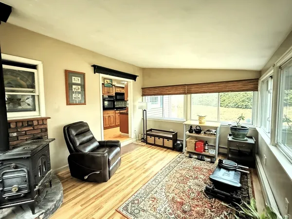 a living room with furniture a flat screen tv and large windows