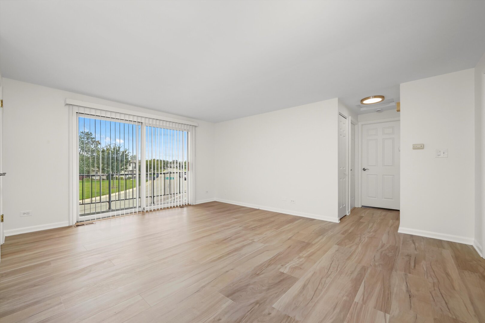 1100 Stoughton Court, Unit 1711 Schaumburg, IL 60193 - Photo 12 of 20 a view of an empty room with wooden floor and a window