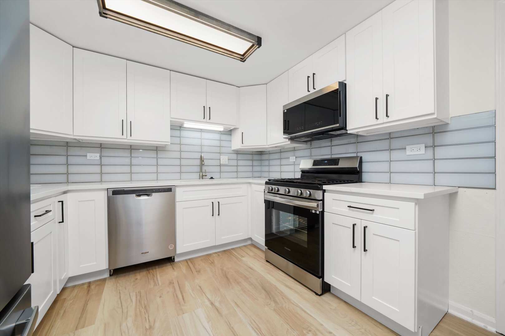 1100 Stoughton Court, Unit 1711 Schaumburg, IL 60193 - Photo 3 of 20 a kitchen with white cabinets stainless steel appliances and sink