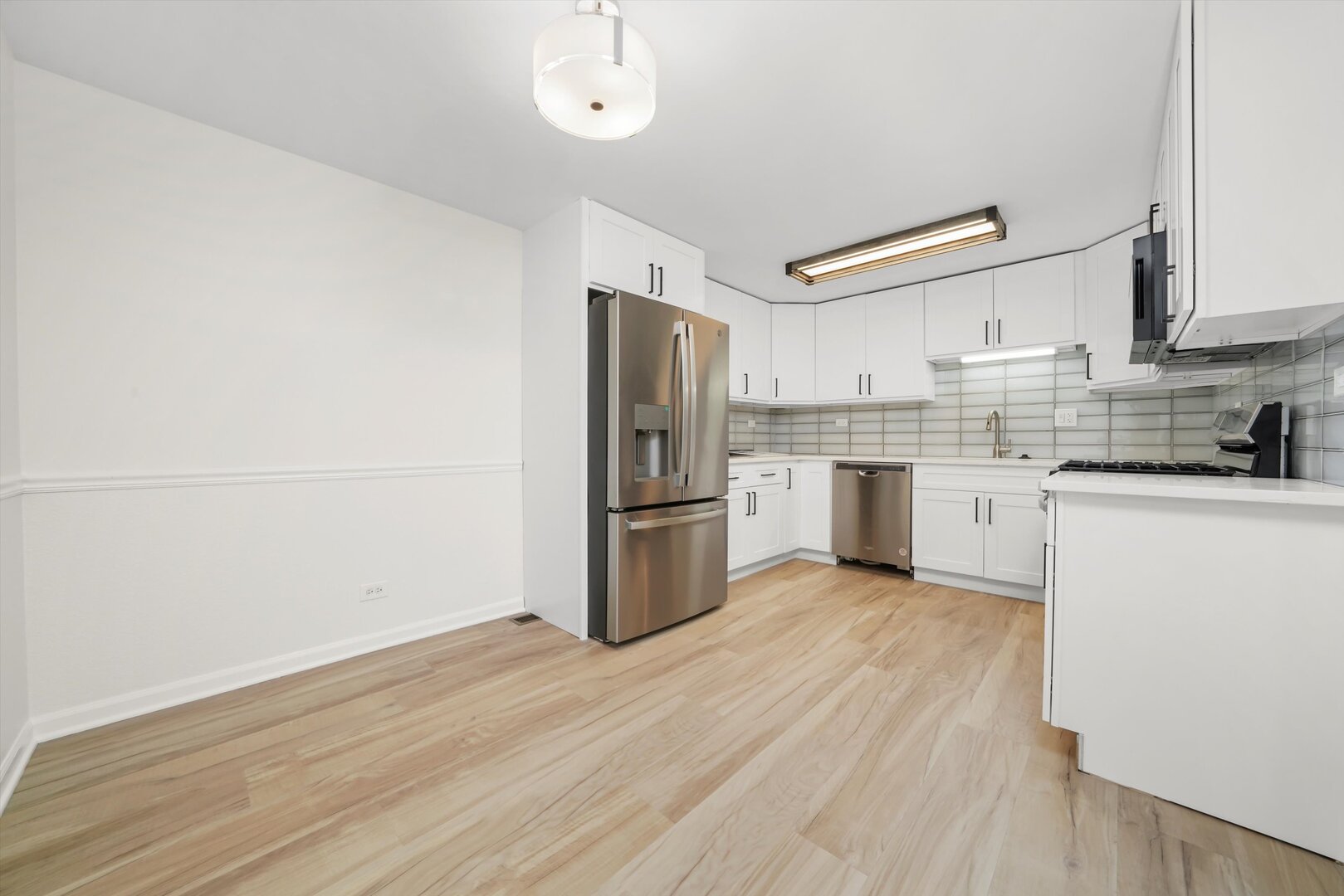 1100 Stoughton Court, Unit 1711 Schaumburg, IL 60193 - Photo 4 of 20 a kitchen with a refrigerator sink and cabinets