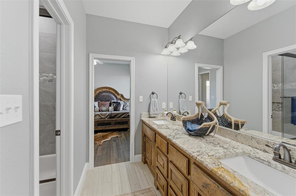 10106 Prather Road Springtown, TX 76082 - Photo 20 of 40 a bathroom with a sink double vanity and a mirror