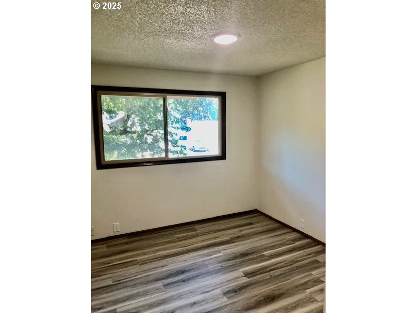 2765 Almaden Street Eugene, OR 97405 - Photo 13 of 24 a view of a room with wooden floor and a window
