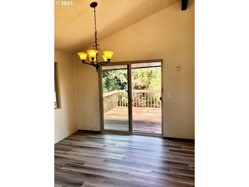 2765 Almaden Street Eugene, OR 97405 - Photo 5 of 24 a view of a room with wooden floor and a floor to ceiling window