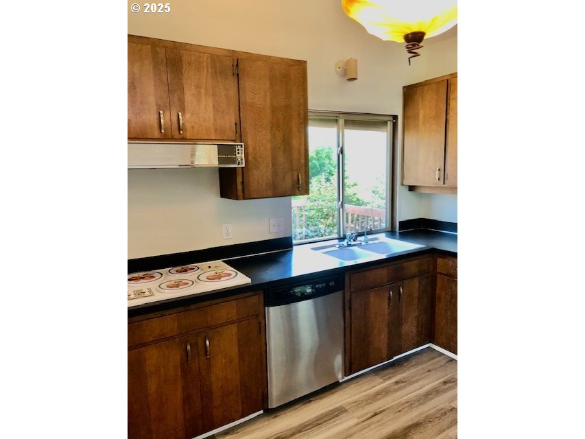 2765 Almaden Street Eugene, OR 97405 - Photo 7 of 24 a kitchen with stainless steel appliances granite countertop a stove a sink and a microwave