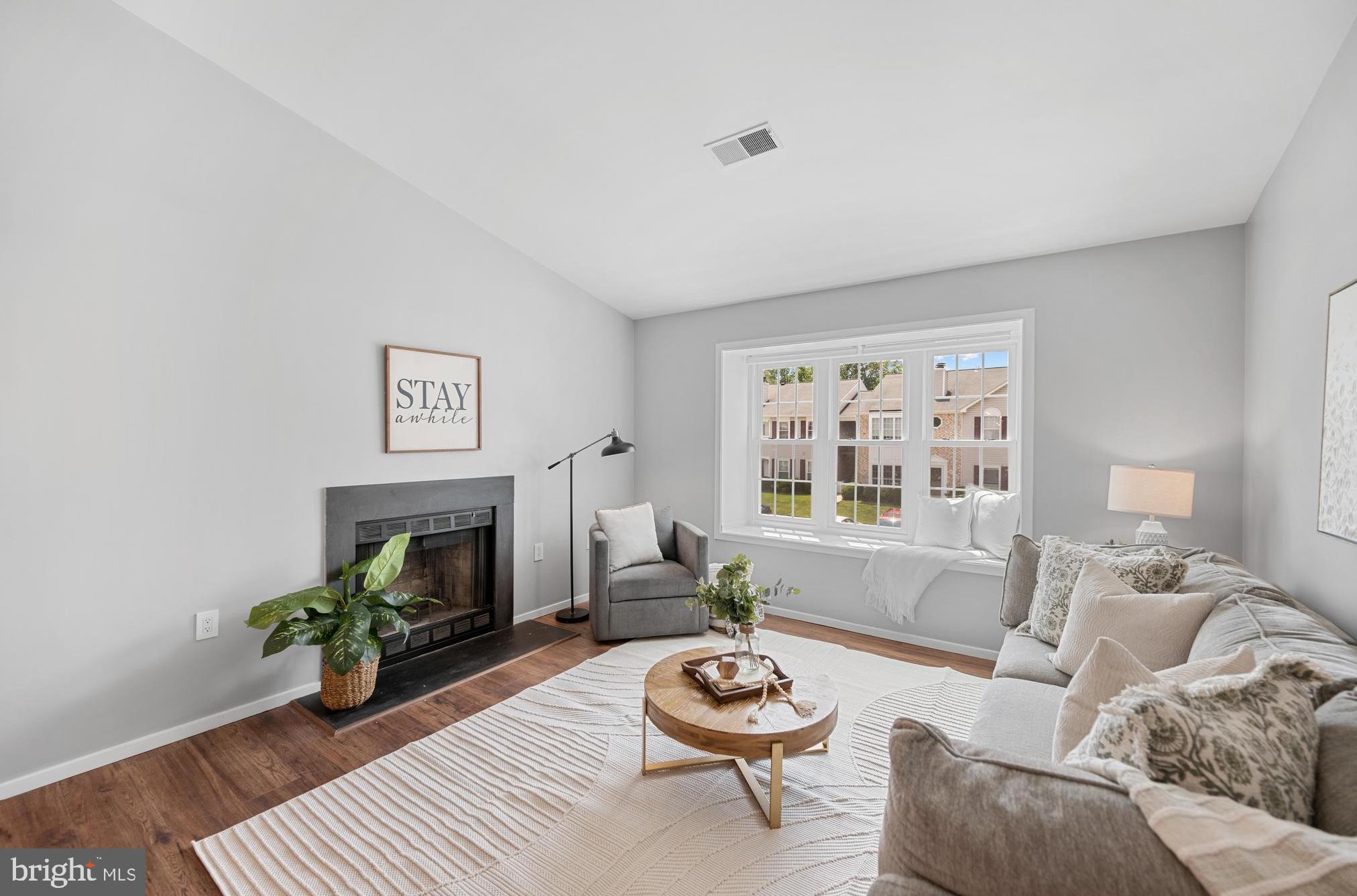 7826 Harrowgate Circle, Unit D Springfield, VA 22152 - Photo 1 of 21 a living room with furniture and a fireplace