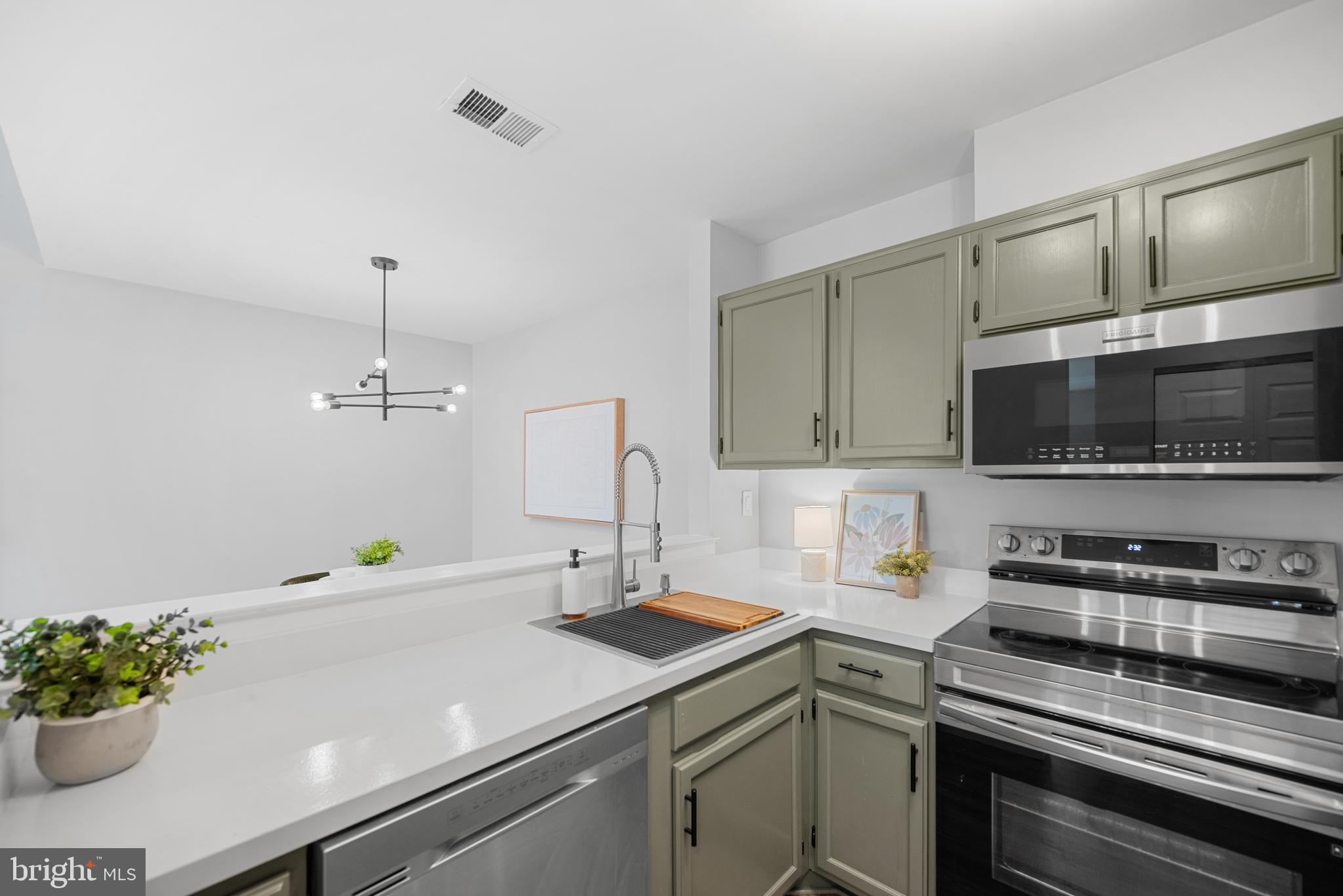 7826 Harrowgate Circle, Unit D Springfield, VA 22152 - Photo 8 of 21 a kitchen with a sink and a microwave