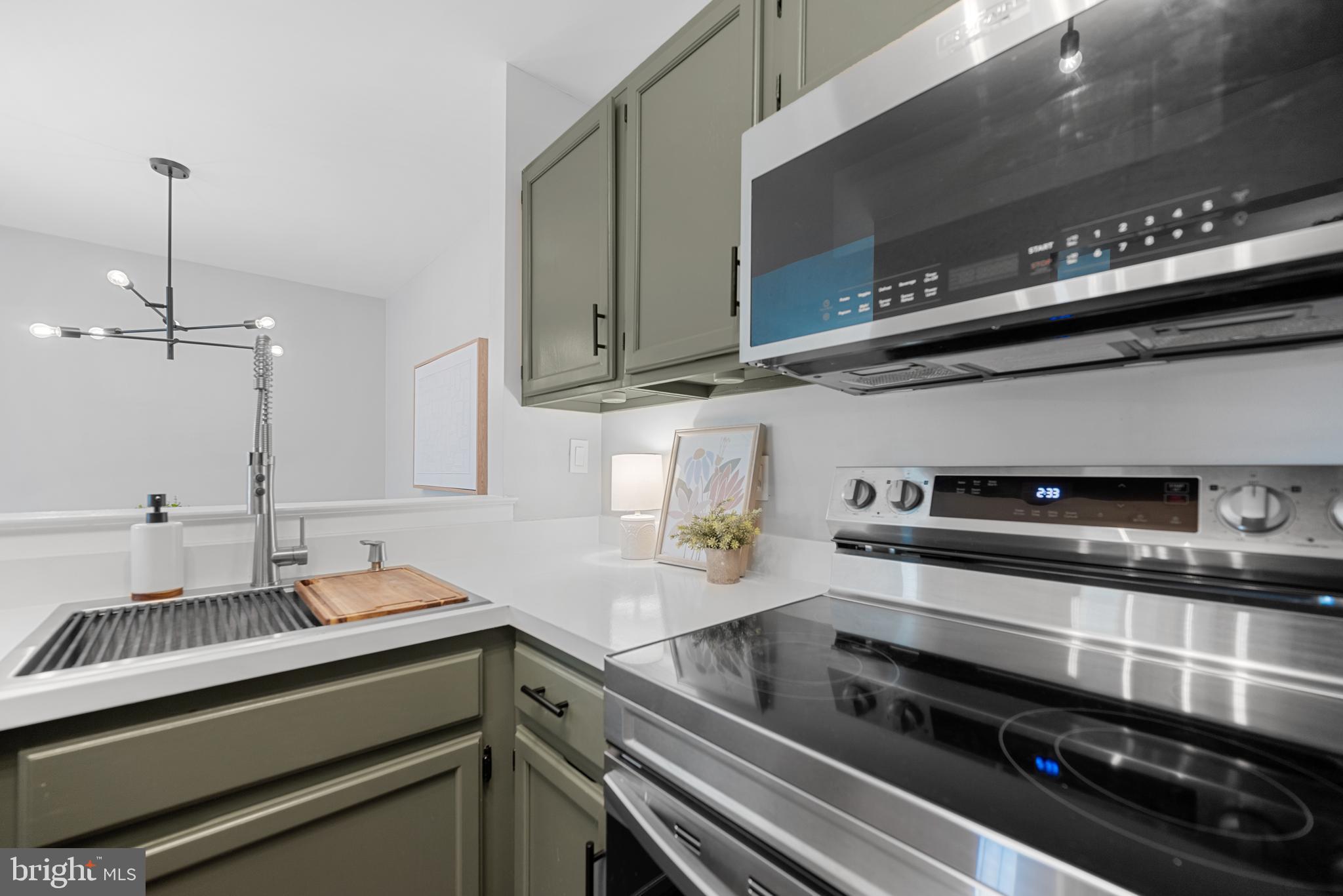 7826 Harrowgate Circle, Unit D Springfield, VA 22152 - Photo 9 of 21 a kitchen with stainless steel appliances and a sink