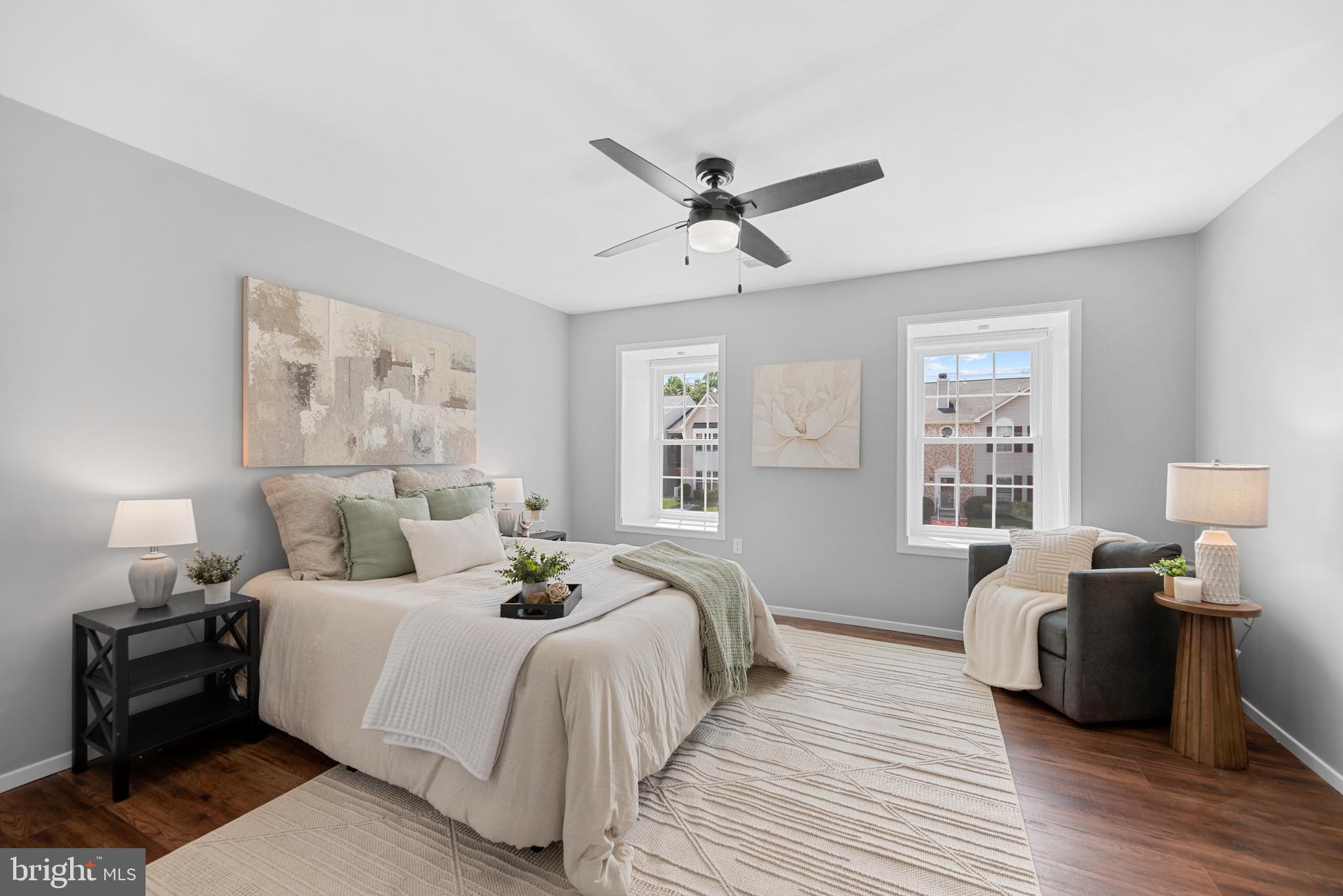 7826 Harrowgate Circle, Unit D Springfield, VA 22152 - Photo 11 of 21 a bedroom with a bed and wooden floor