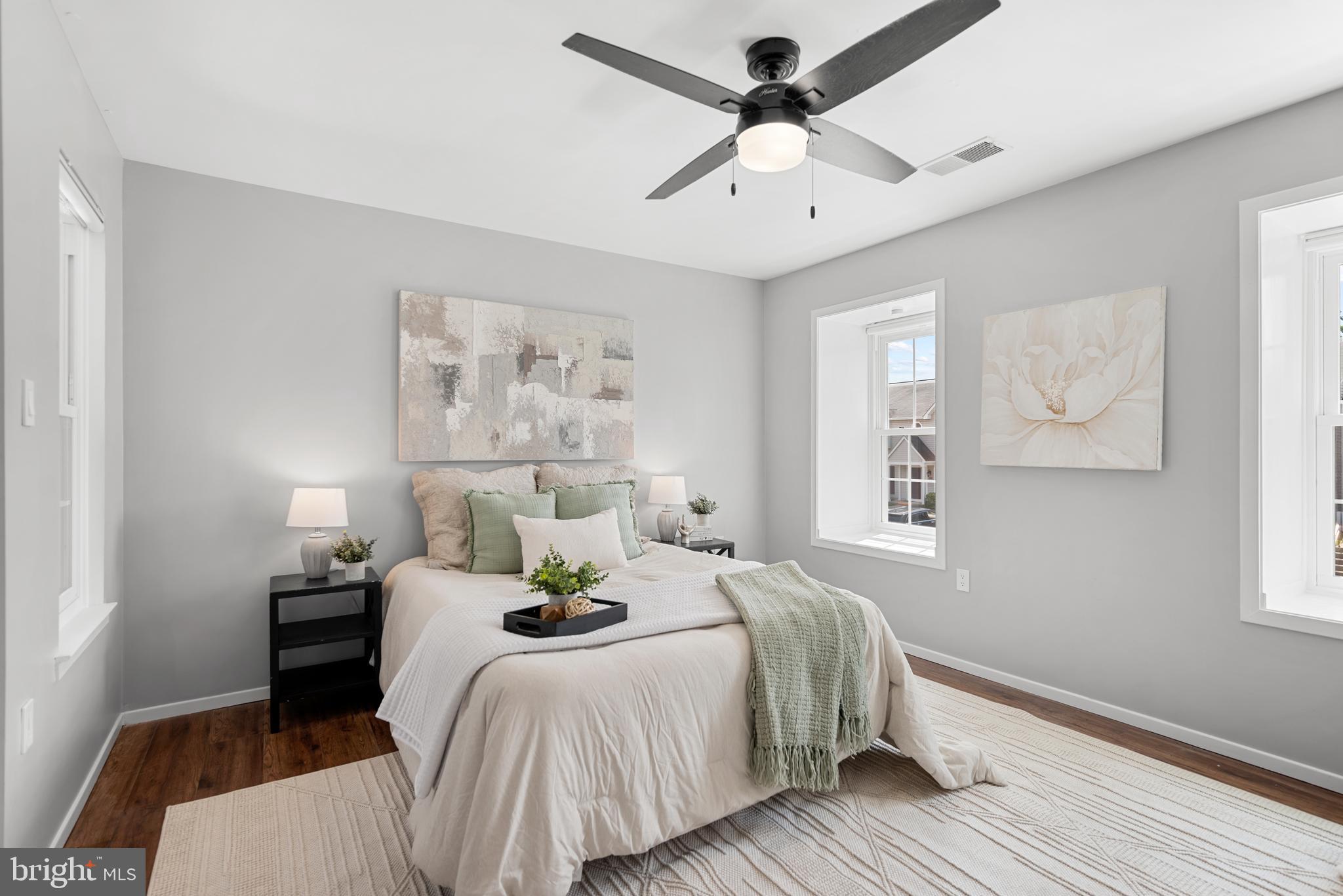 7826 Harrowgate Circle, Unit D Springfield, VA 22152 - Photo 12 of 21 a bedroom with a bed wooden floor and a ceiling fan