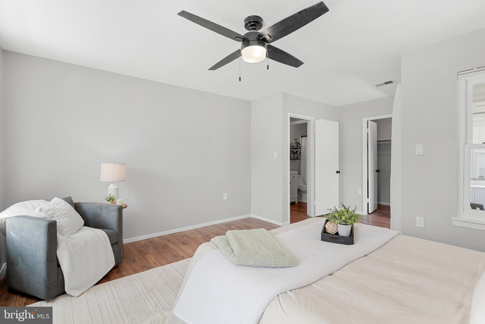7826 Harrowgate Circle, Unit D Springfield, VA 22152 - Photo 14 of 21 a bedroom with bed and a chandelier