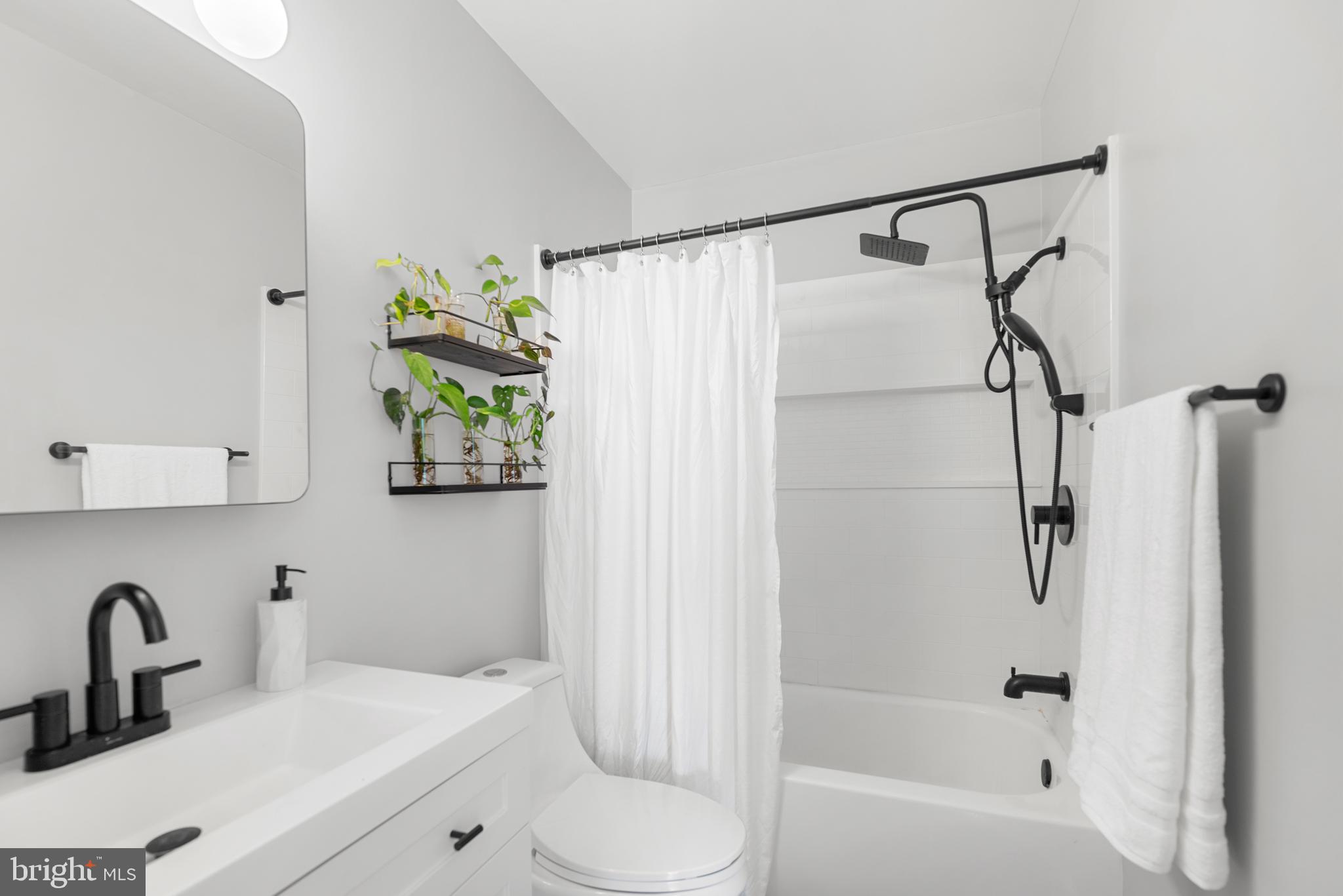 7826 Harrowgate Circle, Unit D Springfield, VA 22152 - Photo 15 of 21 a bathroom with a sink toilet and shower