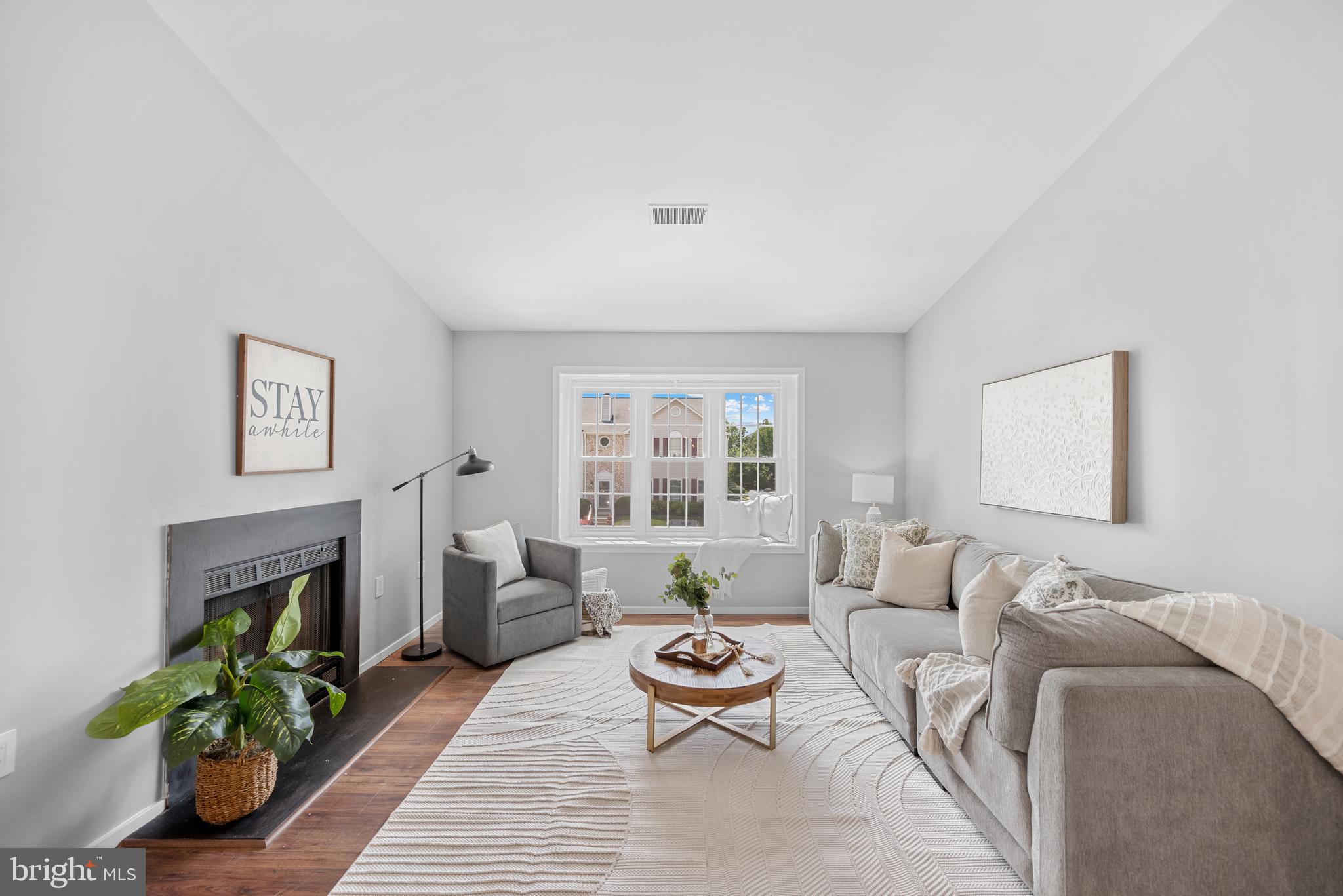 7826 Harrowgate Circle, Unit D Springfield, VA 22152 - Photo 2 of 21 a living room with furniture and a fireplace