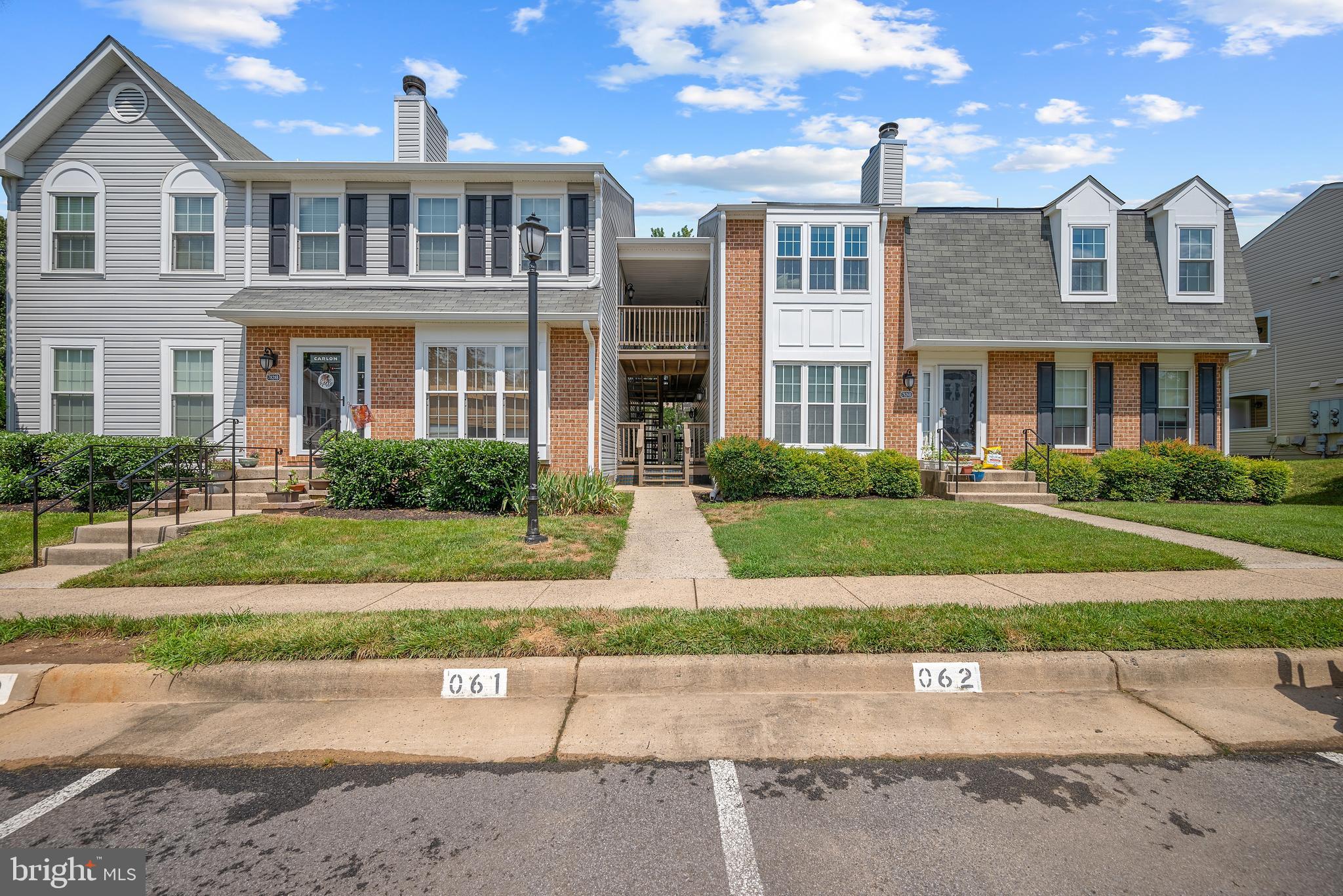 7826 Harrowgate Circle, Unit D Springfield, VA 22152 - Photo 18 of 21 a front view of a house with a yard and a garage